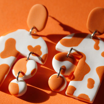 Boucles d'oreilles - tâche de vache tarracotta | Collection Permanente